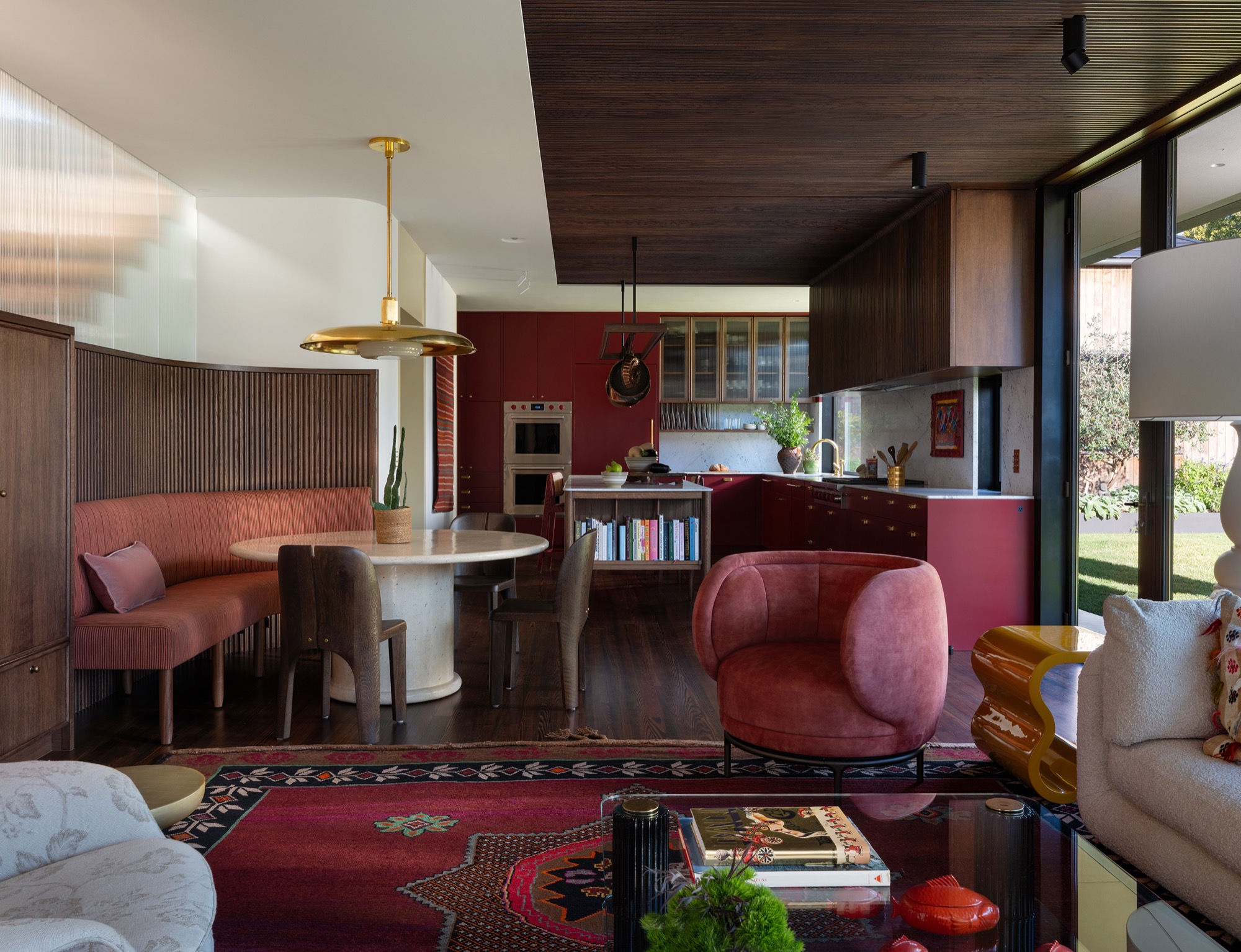 Victorian House red kitchen with pot rack and banquette in Austin, Texas